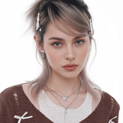 Front view of a model wearing layered cloud-and-star necklaces and matching earrings.