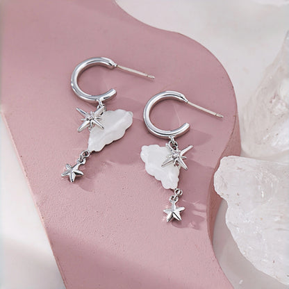 Cloud and star hoop earrings close-up, silver hoops with mother-of-pearl cloud charms and dangling star drops
