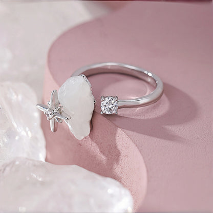 Cloud and star ring close-up, open silver ring with a mother-of-pearl cloud and star accent on one side and a clear crystal on the other