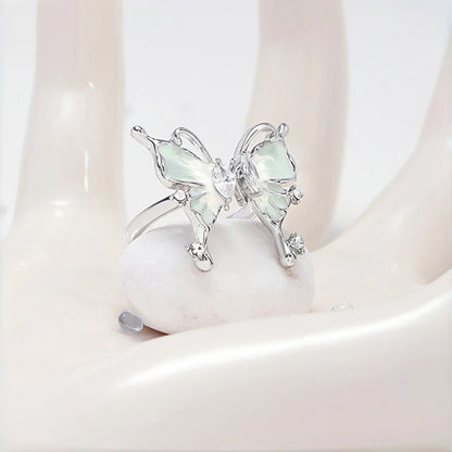 Fairy iridescent butterfly ring close-up, open silver ring with a mint enamel butterfly charm and clear crystal accents