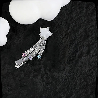 Fairy shooting star hair clip close-up, silver star charm with tasselled strands and pink, purple and blue crystal star drops