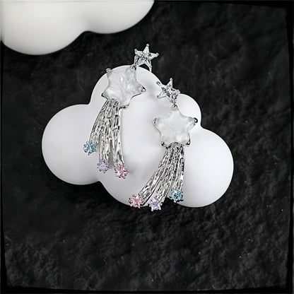 Fairy shooting star drop earrings close-up, pair of silver star studs with mother-of-pearl star charms, tasselled strands and pastel crystal star drops