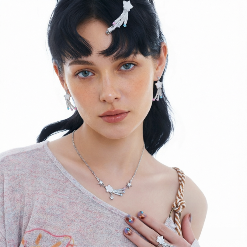 Model wearing the Fairy Shooting Star necklace, matching drop earrings and ring, with a white shooting-star hair clip.