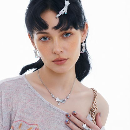 Model wearing the Fairy Shooting Star necklace, matching drop earrings and ring, with a white shooting-star hair clip.