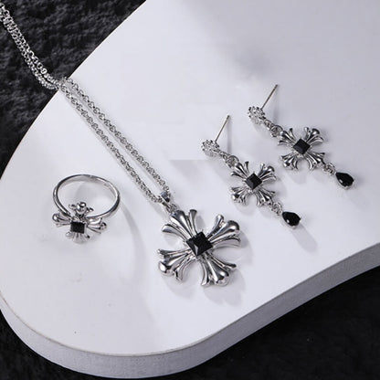 Silver-tone gothic cross necklace, drop earrings and ring displayed together, with black square centres and black teardrop earring charms.