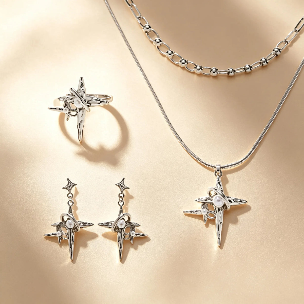 Grunge four-point star jewellery set with pearl accents, silver ring, drop earrings and layered chain necklace