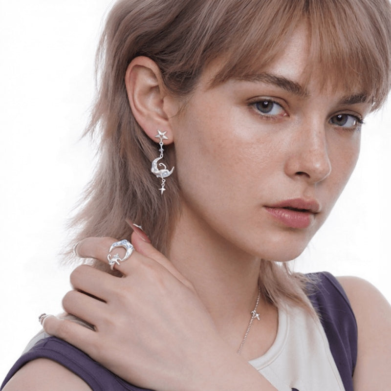 Model wearing a silver-tone crescent moon earring with a cat detail and a matching moon-and-cat ring.