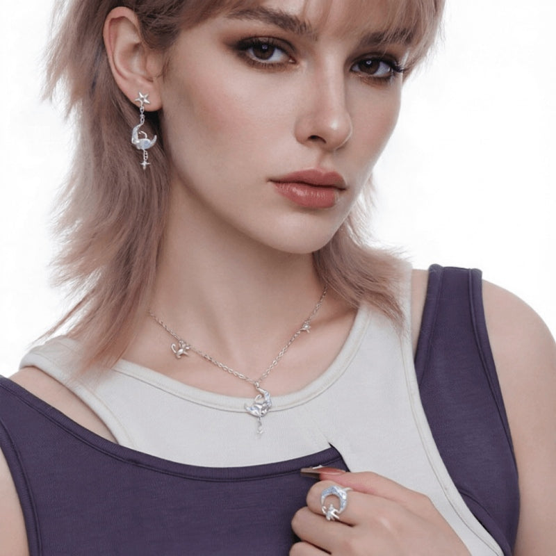 Model wearing a silver-tone cat-and-crescent-moon necklace, matching drop earring and crescent ring.