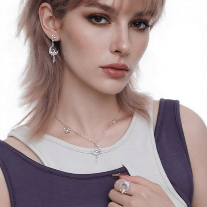 Model wearing a silver-tone cat-and-crescent-moon necklace, matching drop earring and crescent ring.