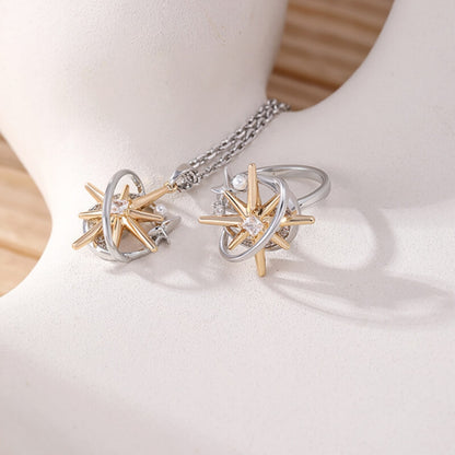 Close-up of a matching starburst pendant and ring with gold-tone rays and silver-tone orbital frames.