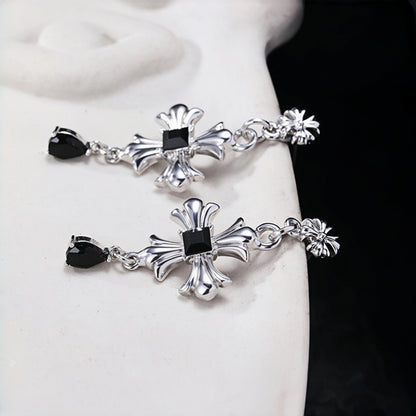 Gothic cross earrings close-up, pair of silver cross drop earrings with black stones and black teardrop charms