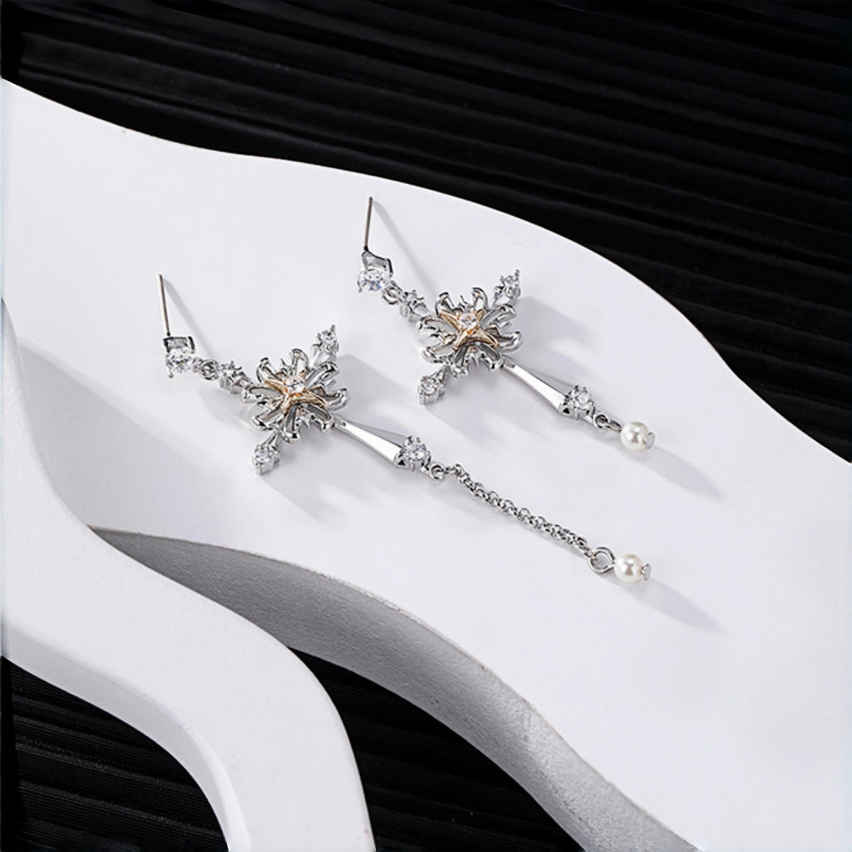 Vintage gothic cross earrings close-up, pair of silver cross drop earrings with rose gold flower centres and dangling pearl charms