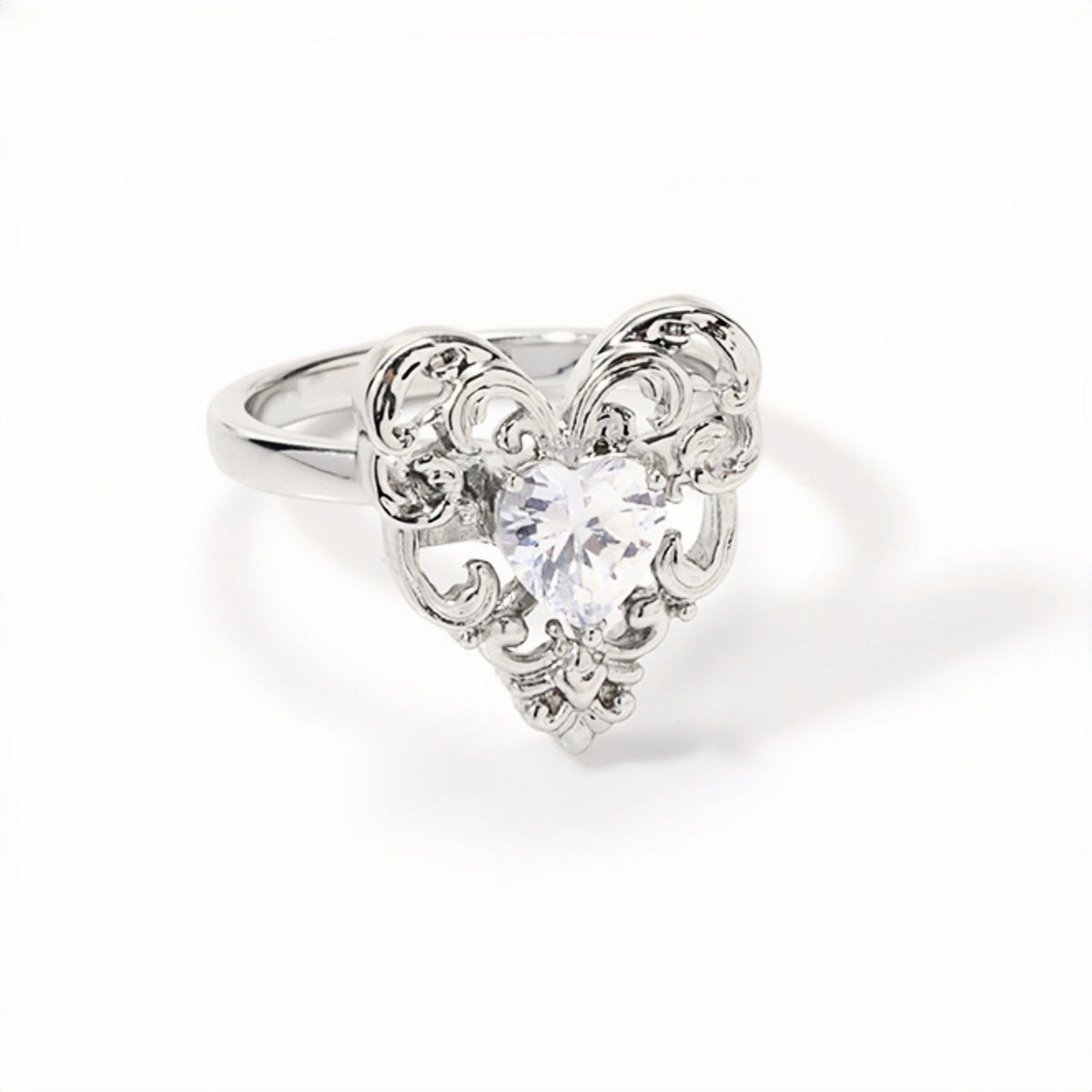 Vintage lace heart ring close-up, silver filigree heart ring with a clear heart-shaped crystal centre stone