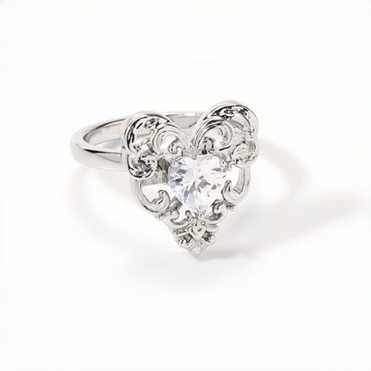 Vintage lace heart ring close-up, silver filigree heart ring with a clear heart-shaped crystal centre stone