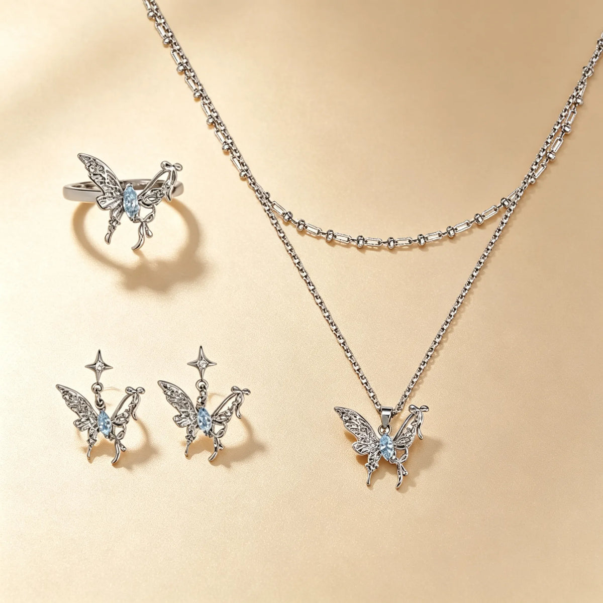 Butterfly jewellery set with blue gemstones, silver ring, stud earrings and layered necklace