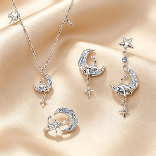 Moon and cat jewellery set with silver crescent pendants, star drops, ring and mismatched earrings