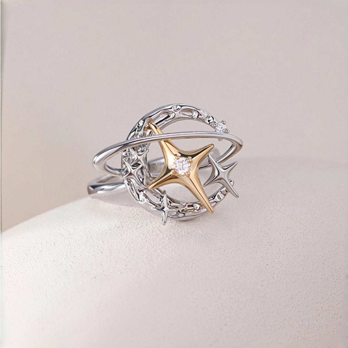 Y2K planet and star ring close-up, silver orbit band with gold star charm and small star accents