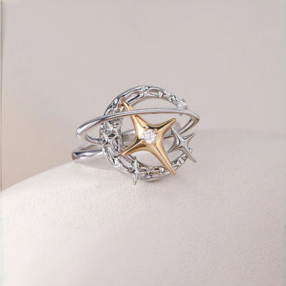 Y2K planet and star ring close-up, silver orbit band with gold star charm and small star accents