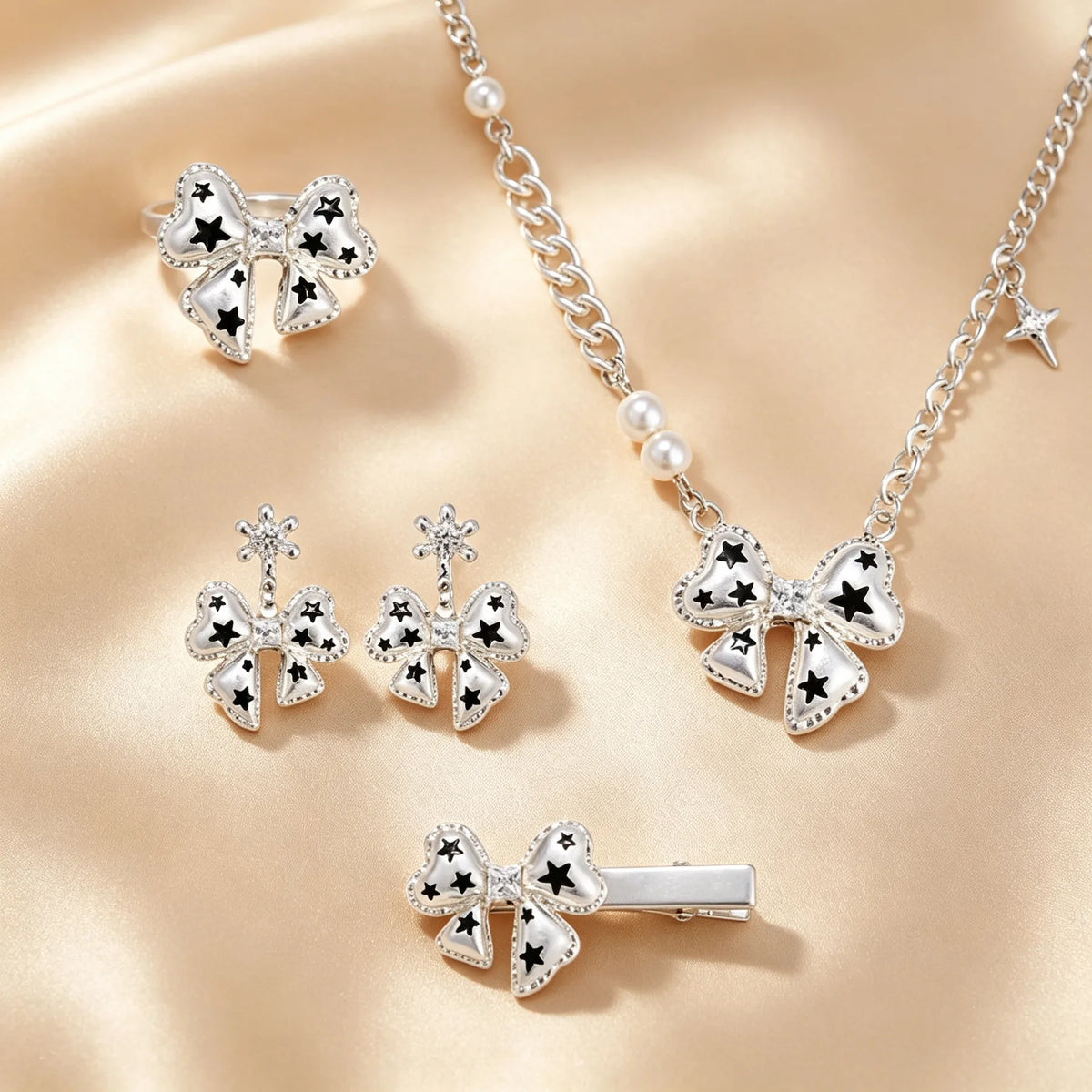 Silver bow jewellery set with black stars, ring, drop earrings, pearl chain necklace and hair clip